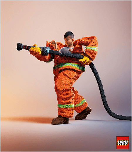 यह एक लेगो विज्ञापन की एक तस्वीर है जो एक युवा एशियाई लड़के को लेगो से बने फायर फाइटर वर्दी के अंदर दिखाती है। वर्दी नारंगी है जिसमें कोट और पैंट के कफ के चारों ओर एक नीयन हरी पट्टी है। फायर फाइटर एक पैर के साथ खड़ा होता है और फायरहोज पकड़ता है, जो लेगो से बना होता है। लड़के का सिर वर्दी के ऊपर से दिखाई देता है, जो कि उसकी तुलना में बहुत बड़ा है और कंधों के आसपास रुकता है। फोटो एक सादे तटस्थ पृष्ठभूमि के खिलाफ लिया गया था। लेगो लोगो निचले दाईं ओर एक लाल बॉक्स में दिखाई देता है। तालिया वुल्फ का कहना है कि लेगो ब्रांड का एक बेहतरीन उदाहरण है जो विज्ञापन में भावनाओं का उपयोग करता है।
